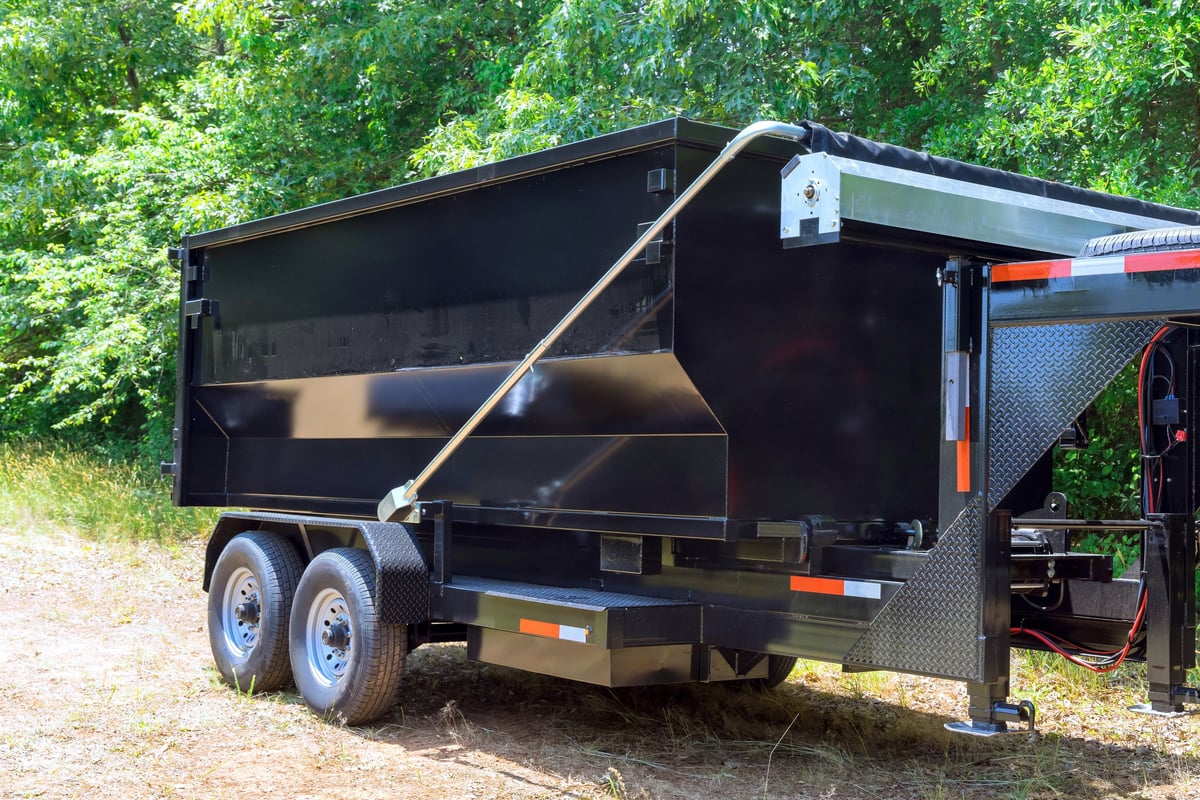 Truck unloading a container of debris for hauling