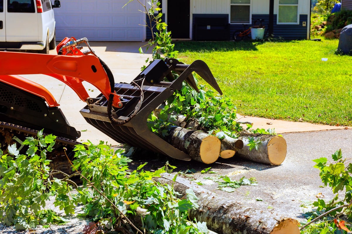 Heavy debris being cleared out of a residential driveway
